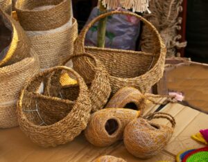 Artisanal woven baskets and handcrafted bird nests for sale at a cultural market.